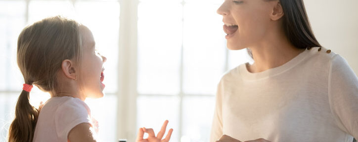 Speech therapist working on communication disorder with young girl