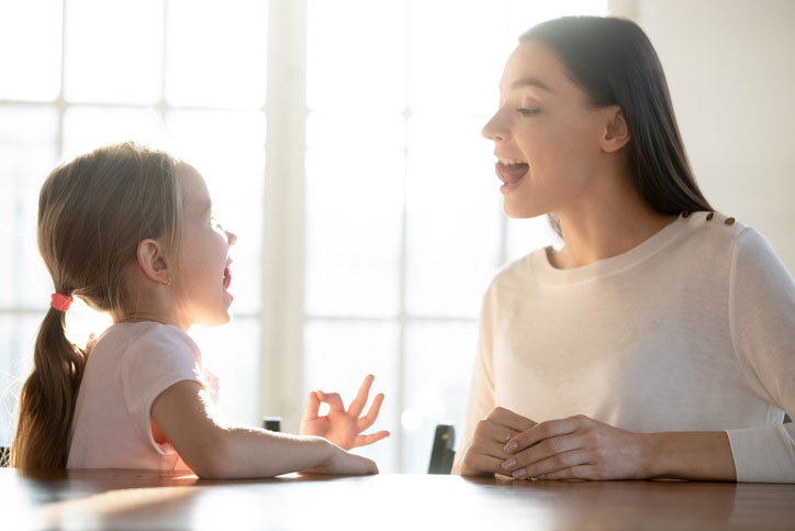 Speech therapist working on communication disorder with young girl