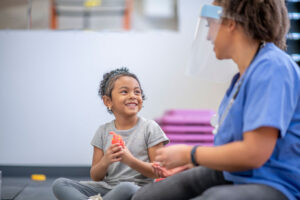 Young girl working with female pediatric slp