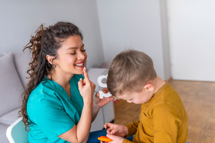 young boy with speech therapist