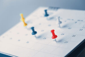 push pins on calendar marking appointments