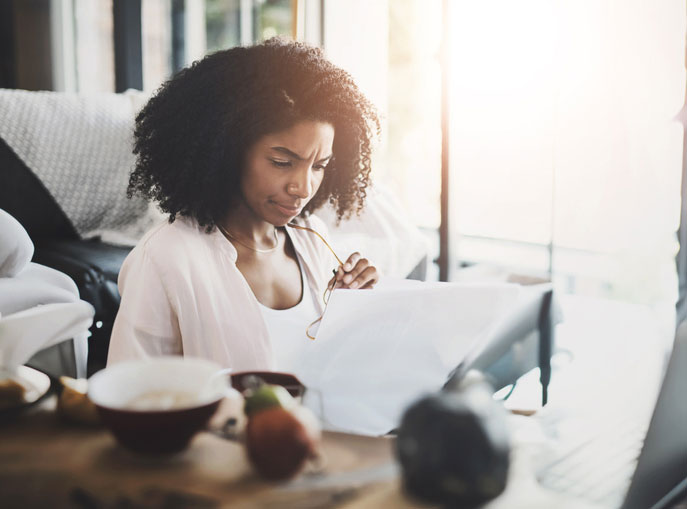 woman looking at student loans confusingly 
